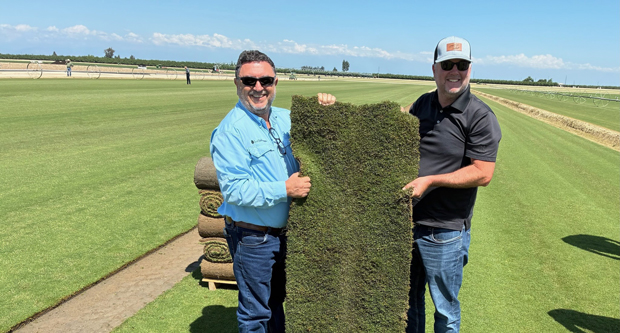 Roberto Gurgel and Joel Lane with a slab of HighPoint Bermudagrass. (Photo: Sod Solutions)